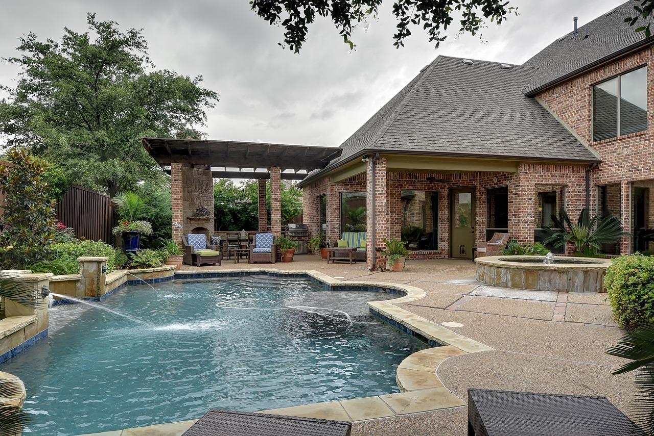 Exposed aggregate concrete pool deck with stone coping in Levy County, Florida