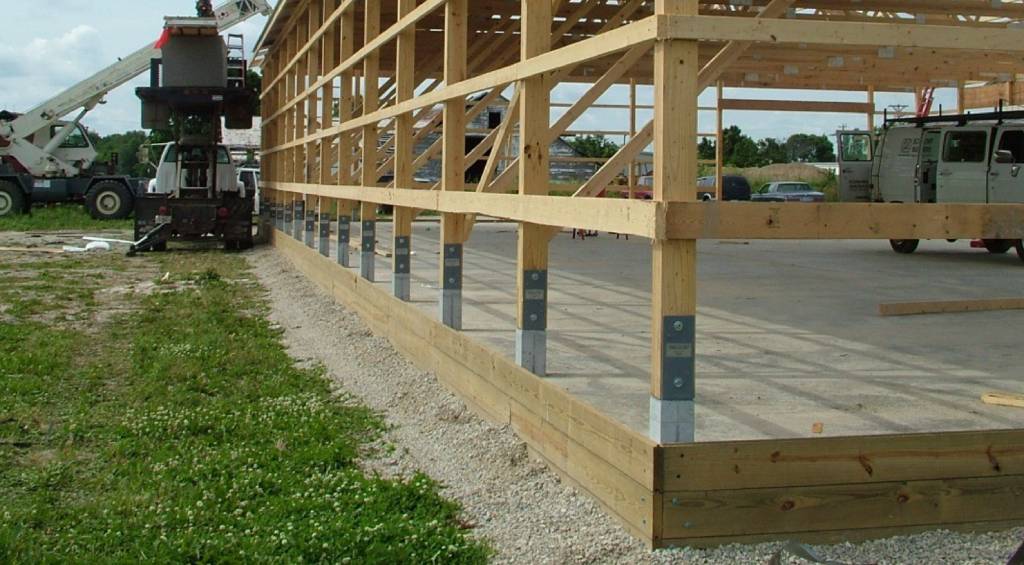 Pole barn concrete slab with pier footings and post brackets in Bell, Florida
