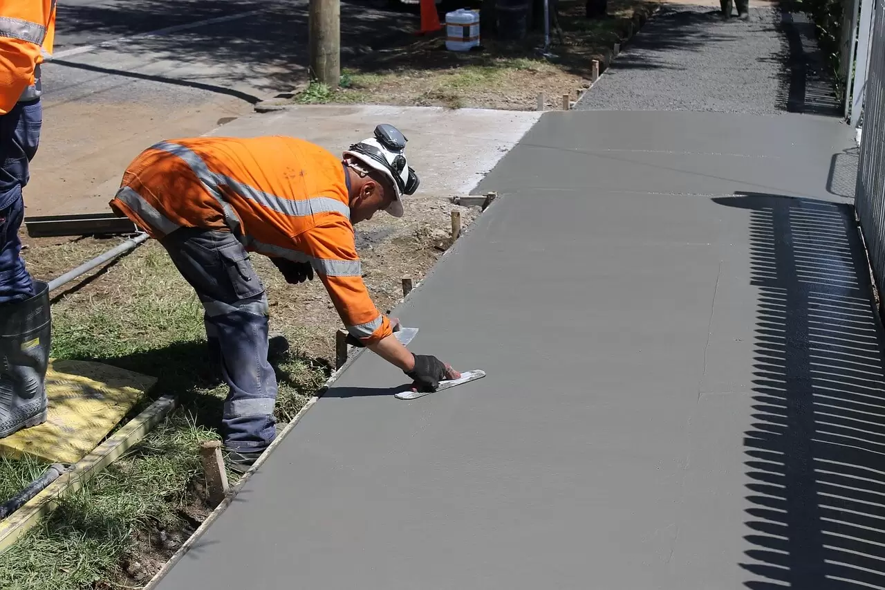 Crew hand-finishing a fresh concrete sidewalk pour in Micanopy, Florida