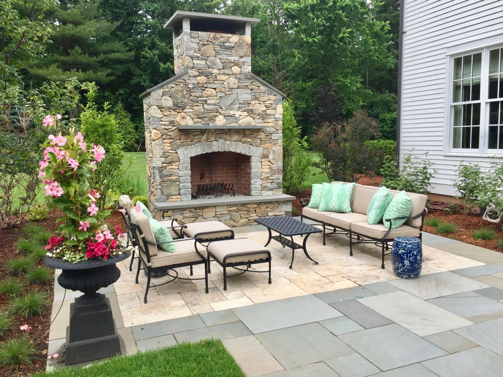 Stone patio with outdoor fireplace and banded border in High Springs, Florida