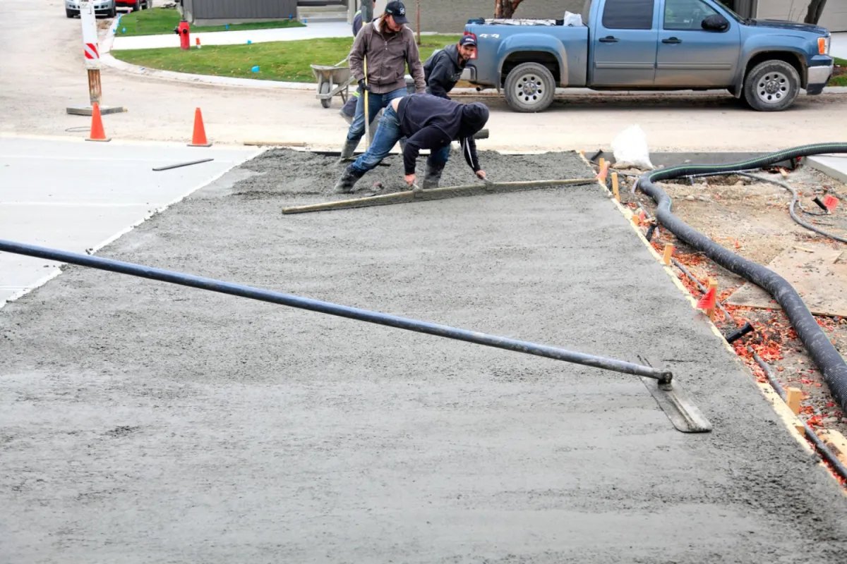Crew screeding a formed concrete pour on a North Central Florida job site