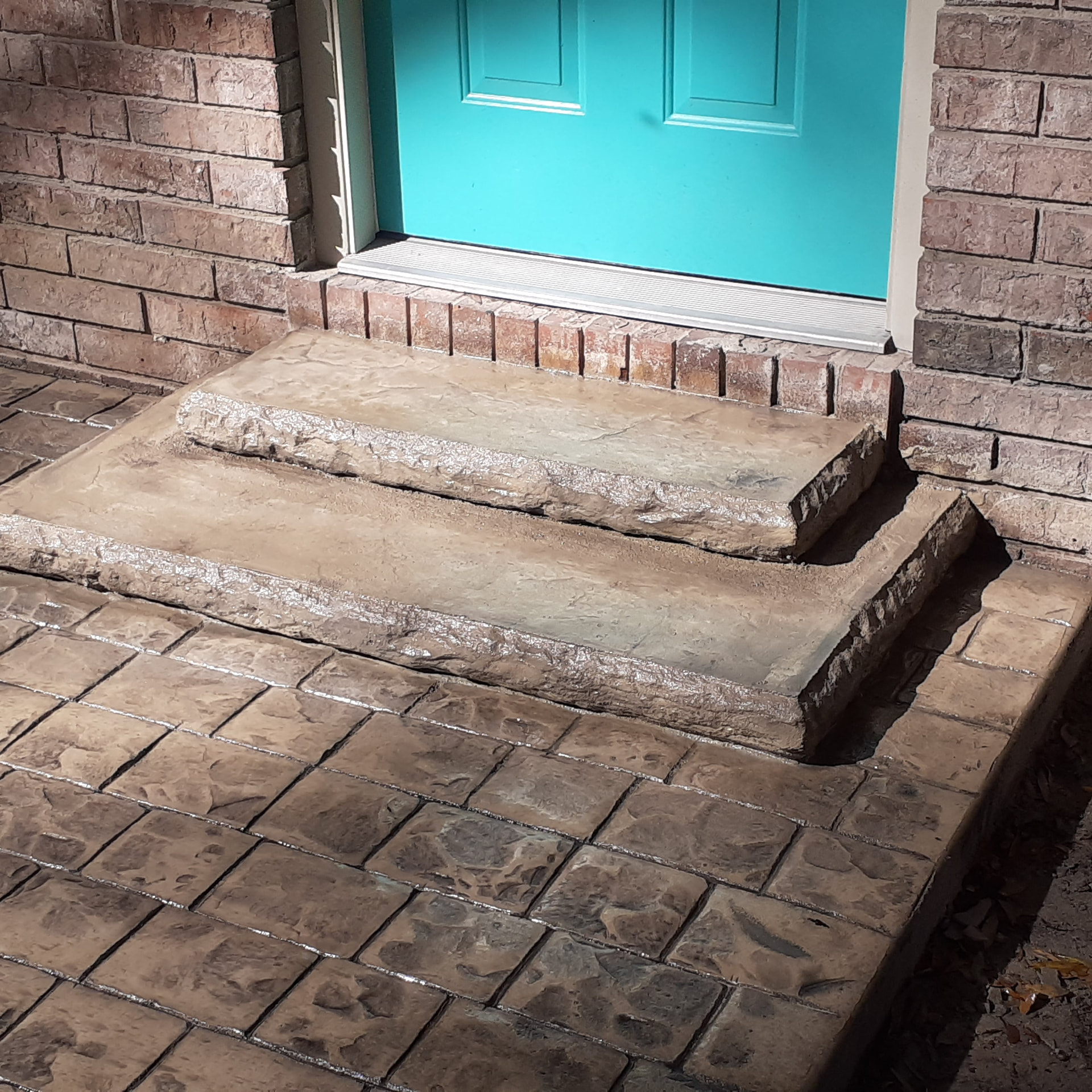 Stamped and stained concrete entry steps with cobble landing in Gainesville, Florida