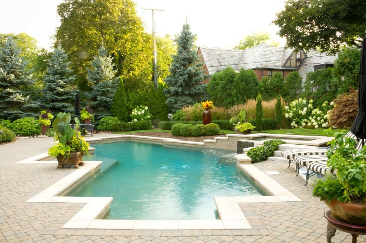 Paver pool deck with concrete coping and spa surround in Bronson, Florida