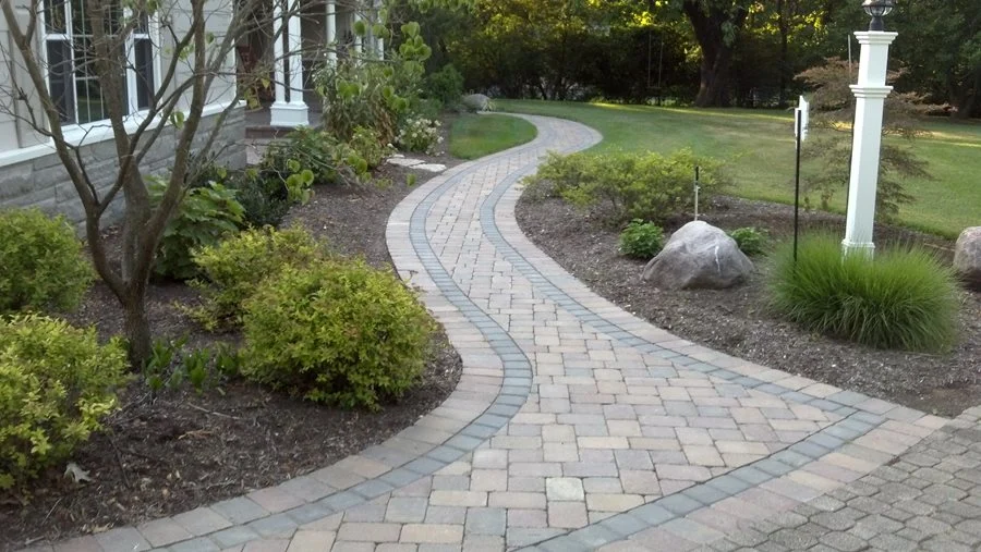 Winding paver-banded walkway on a concrete base in Alachua, Florida