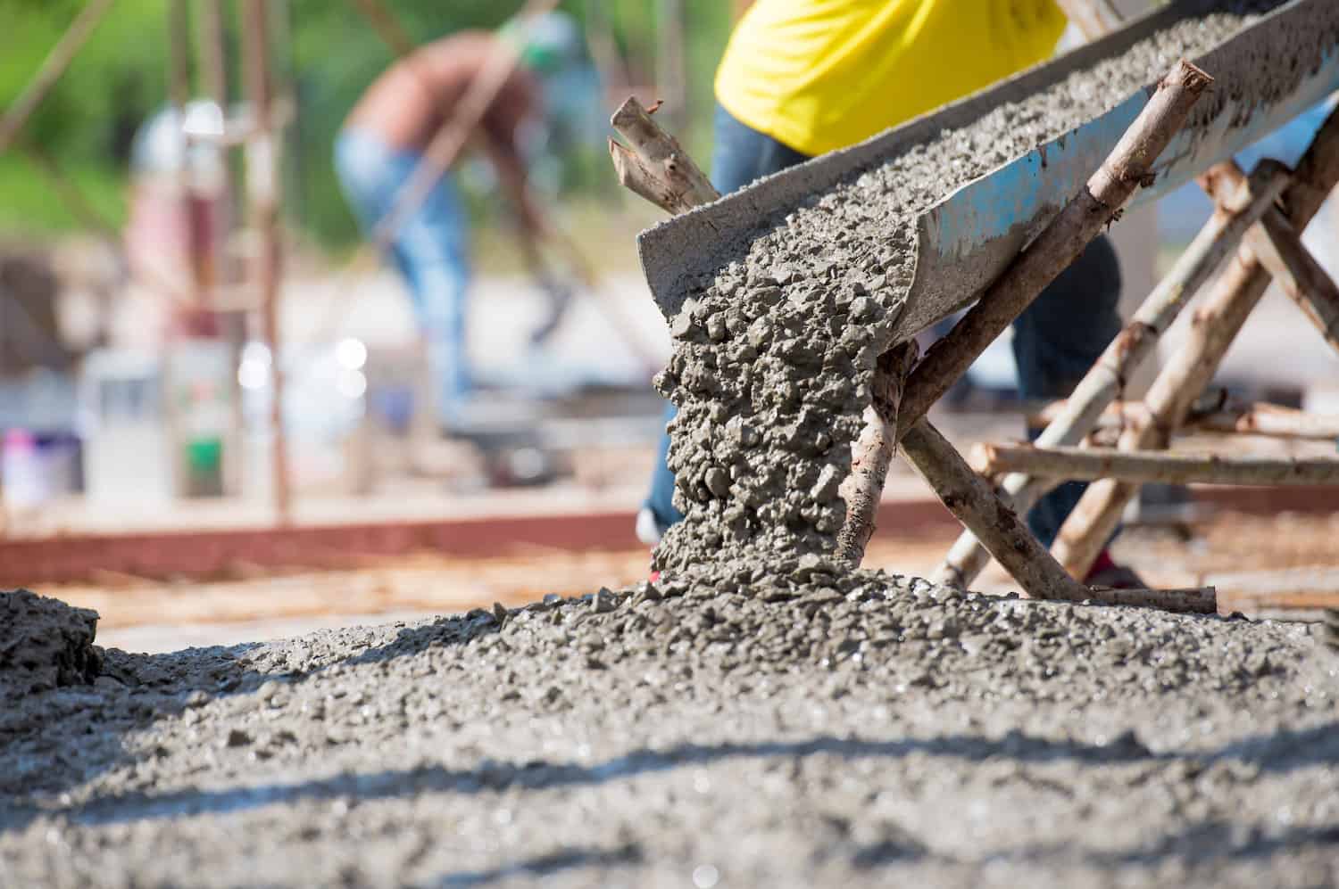 Concrete being poured from a chute onto a reinforced foundation slab in Bronson, Florida