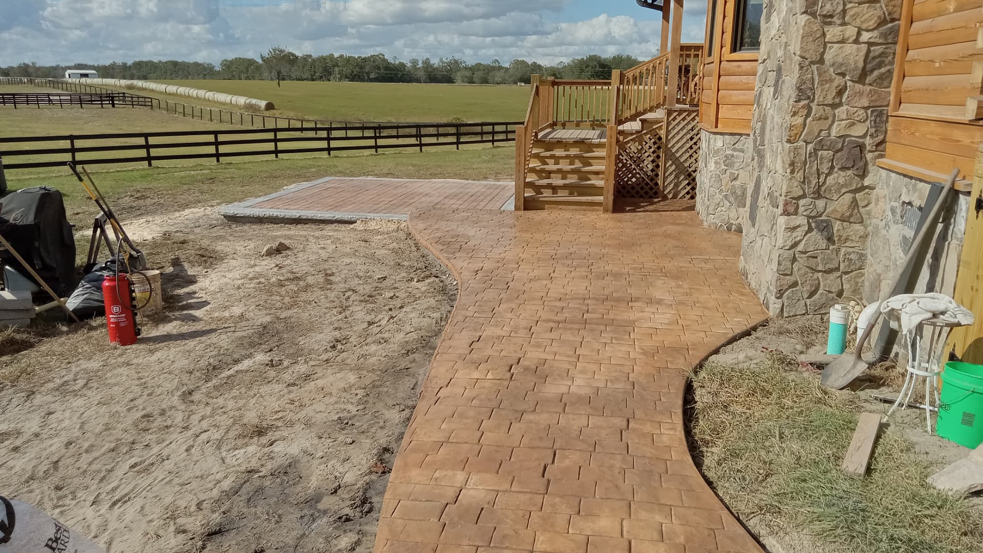 Stamped brick-pattern concrete walkway beside a porch in Trenton, Florida