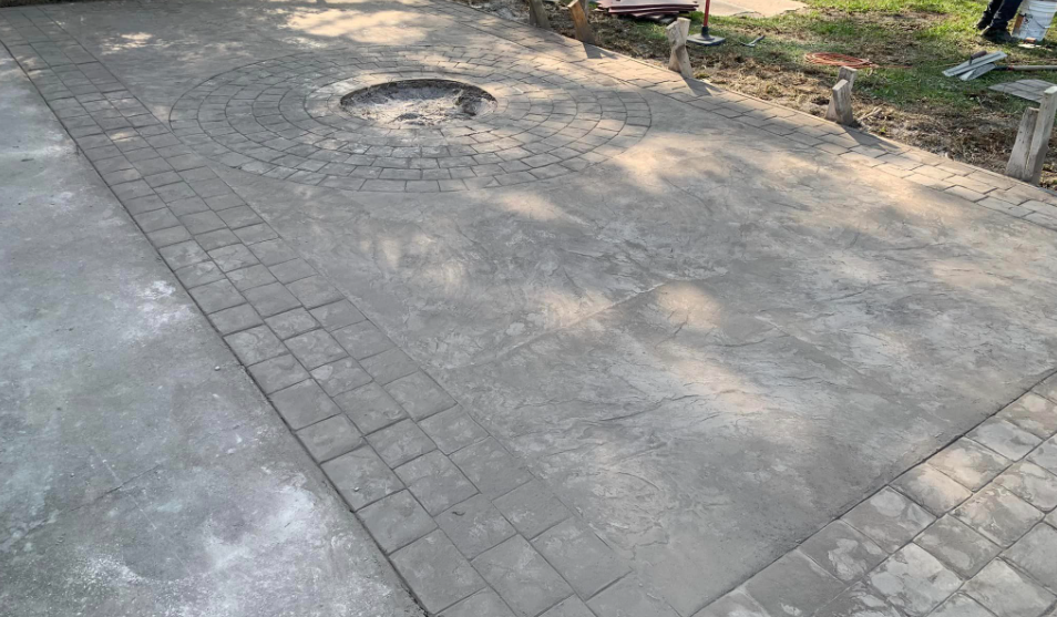Stamped concrete patio with circular fire-pit ring in Archer, Florida