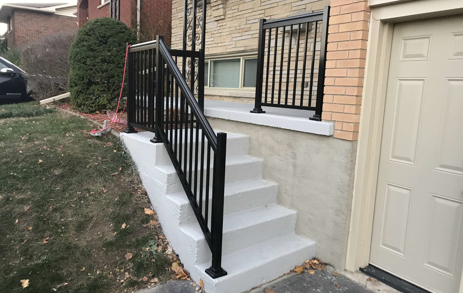 Resurfaced concrete porch steps with new railing in Old Town, Florida