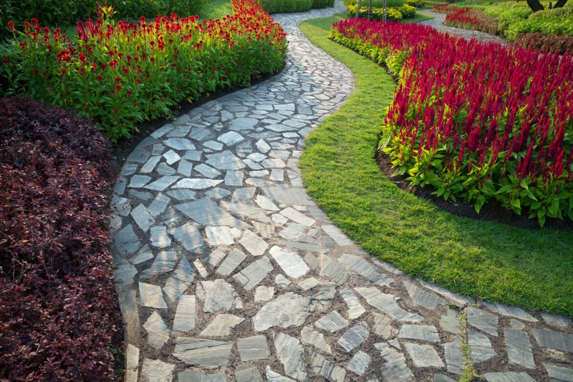 Mosaic flagstone walkway curving through garden beds in High Springs, Florida