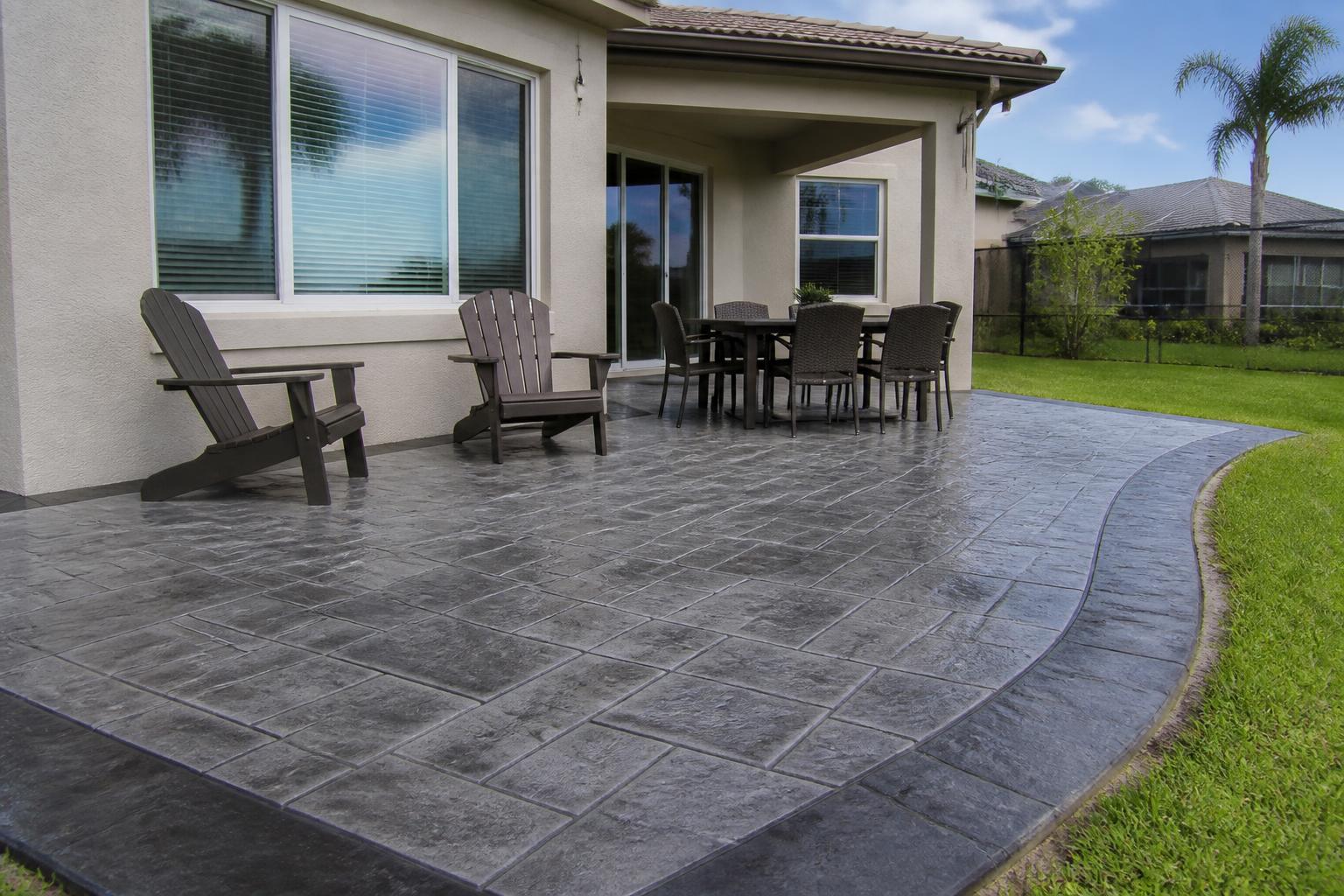 Charcoal slate-stamped concrete patio behind a home in Alachua, Florida