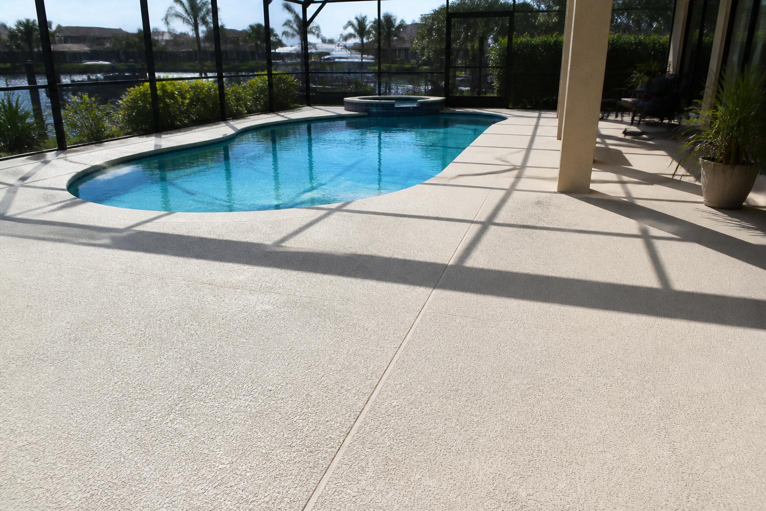 Textured concrete pool deck surround inside a screen enclosure in Marion County, Florida